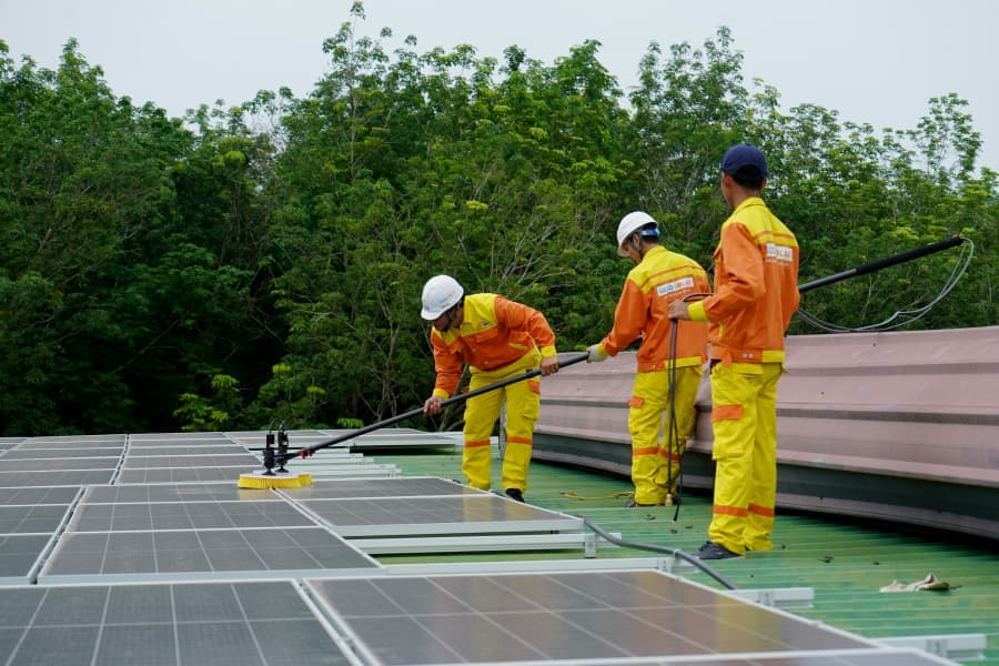 Technician reviewing solar equipment documentation with a homeowner